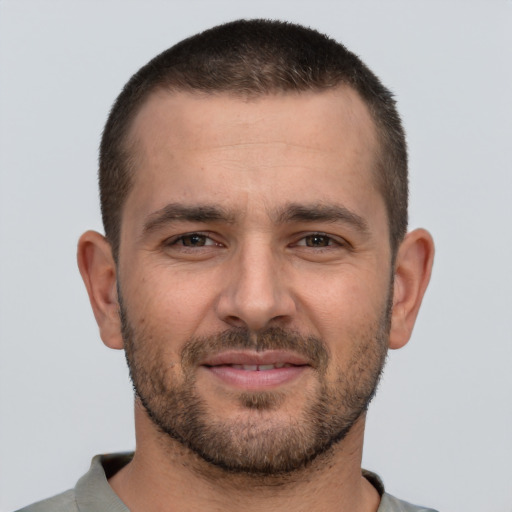 Joyful white young-adult male with short  brown hair and brown eyes