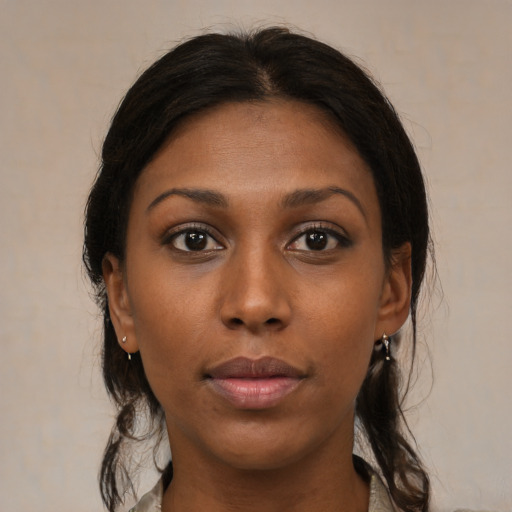 Neutral black young-adult female with medium  brown hair and brown eyes