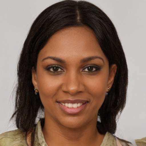 Joyful black young-adult female with medium  brown hair and brown eyes