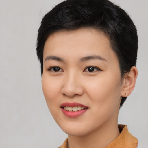 Joyful asian young-adult female with short  black hair and brown eyes
