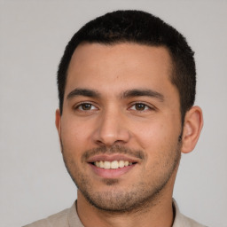 Joyful white young-adult male with short  black hair and brown eyes