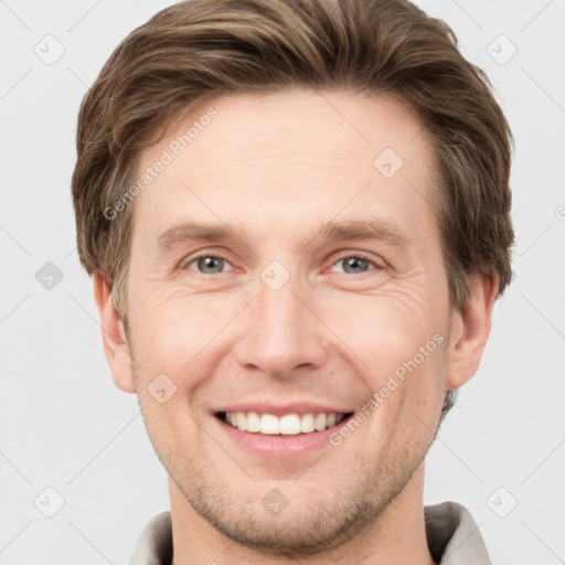 Joyful white young-adult male with short  brown hair and grey eyes