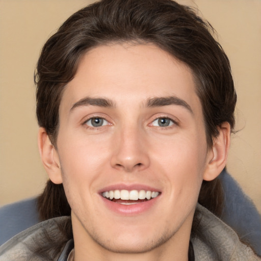 Joyful white young-adult male with medium  brown hair and brown eyes