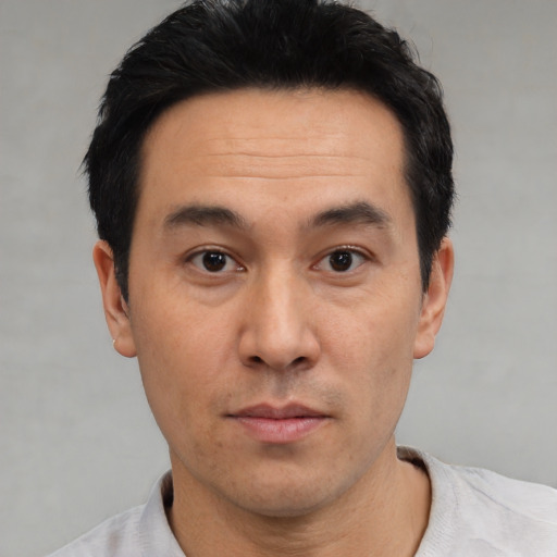 Neutral asian adult male with short  black hair and brown eyes