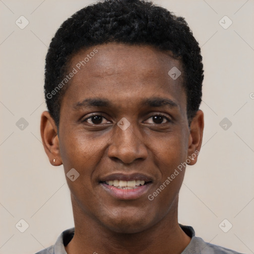 Joyful black young-adult male with short  black hair and brown eyes