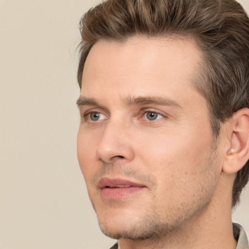 Joyful white young-adult male with short  brown hair and brown eyes