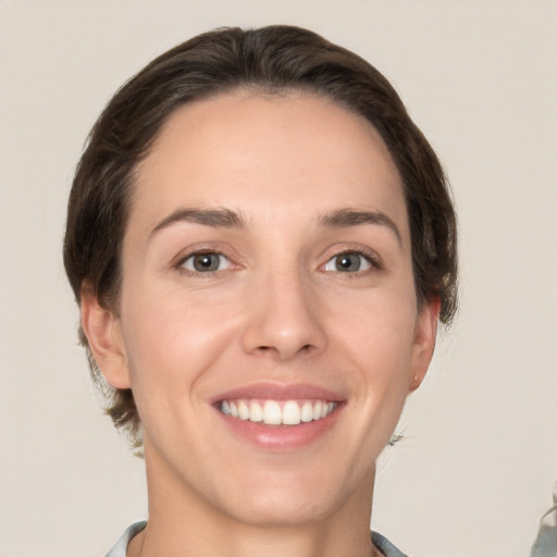 Joyful white young-adult female with short  brown hair and brown eyes