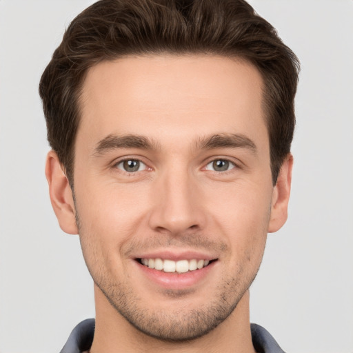 Joyful white young-adult male with short  brown hair and brown eyes