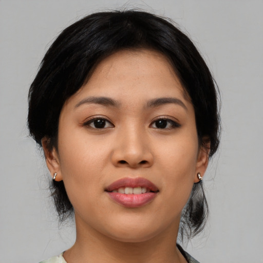 Joyful asian young-adult female with medium  black hair and brown eyes