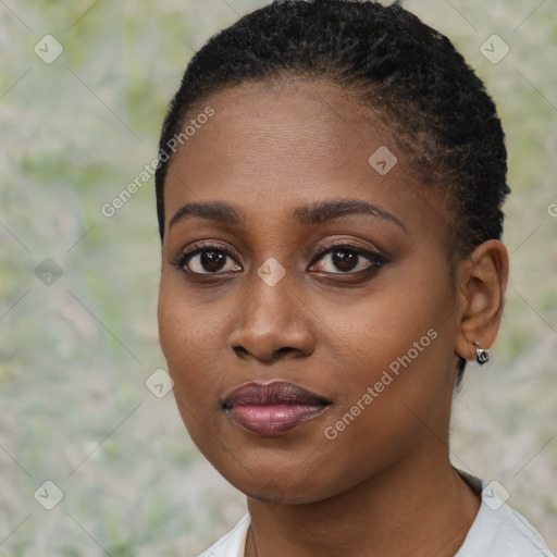 Joyful black young-adult female with short  black hair and brown eyes