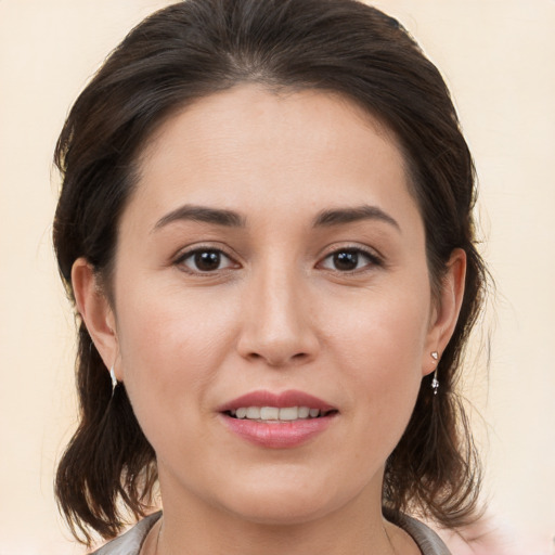 Joyful white young-adult female with medium  brown hair and brown eyes