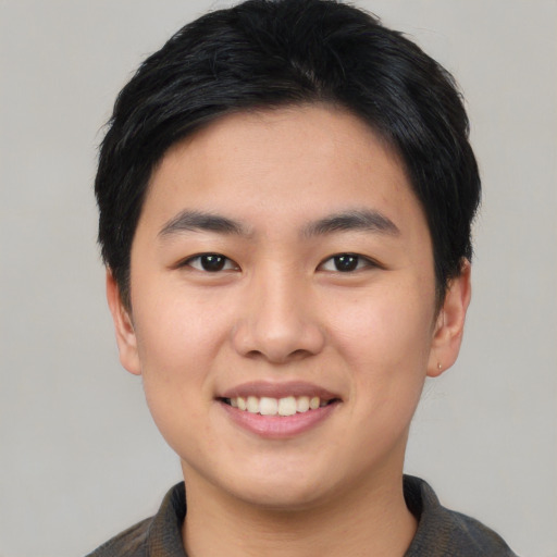 Joyful asian young-adult male with short  black hair and brown eyes