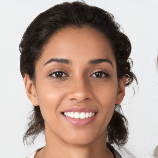 Joyful latino young-adult female with medium  brown hair and brown eyes