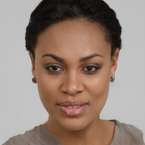 Joyful black young-adult female with short  brown hair and brown eyes