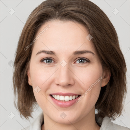 Joyful white young-adult female with medium  brown hair and grey eyes