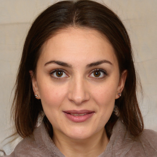 Joyful white young-adult female with medium  brown hair and brown eyes