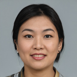 Joyful asian young-adult female with medium  black hair and brown eyes