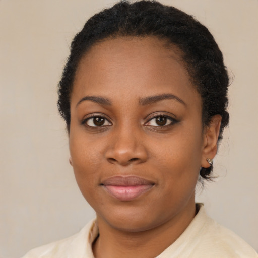 Joyful black young-adult female with medium  brown hair and brown eyes