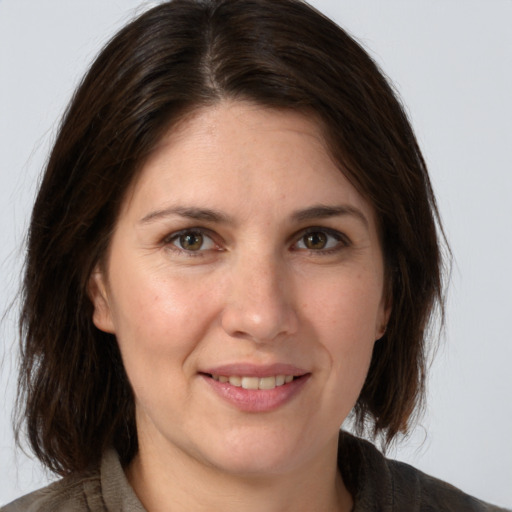 Joyful white adult female with medium  brown hair and brown eyes