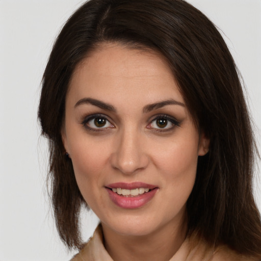 Joyful white young-adult female with long  brown hair and brown eyes