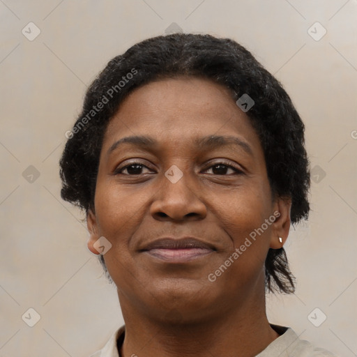 Joyful black adult female with short  brown hair and brown eyes