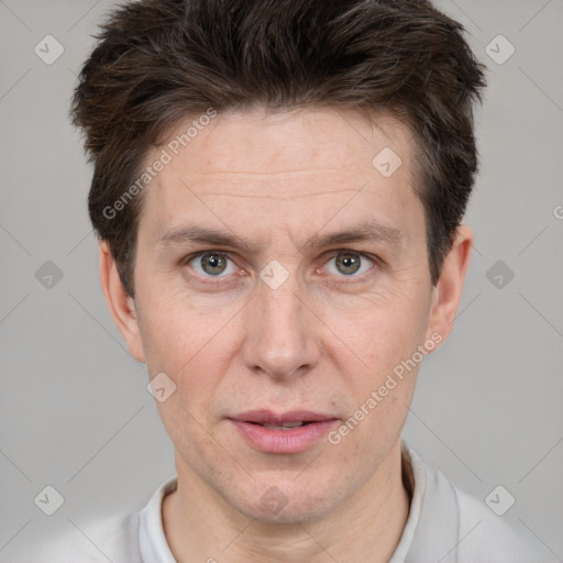 Joyful white adult male with short  brown hair and grey eyes