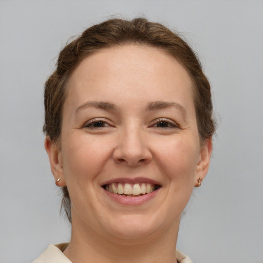 Joyful white adult female with short  brown hair and brown eyes