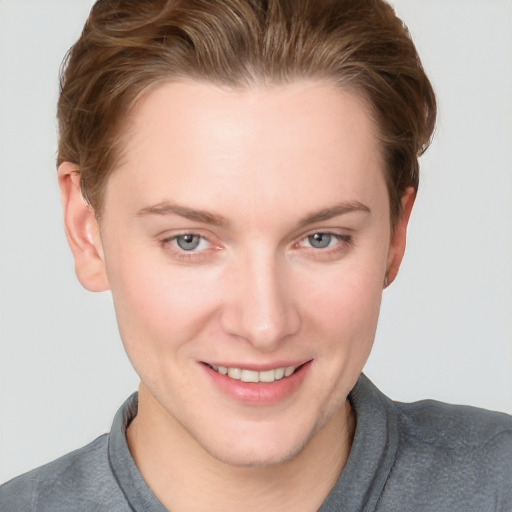 Joyful white young-adult female with short  brown hair and grey eyes