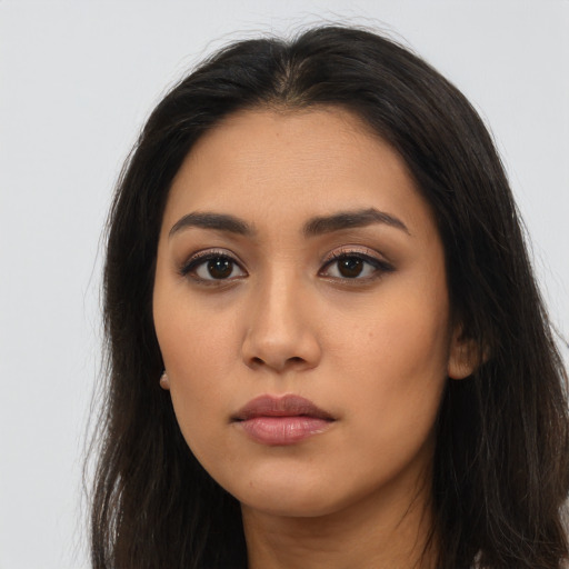 Neutral latino young-adult female with long  brown hair and brown eyes