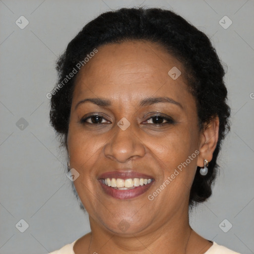 Joyful black adult female with short  brown hair and brown eyes