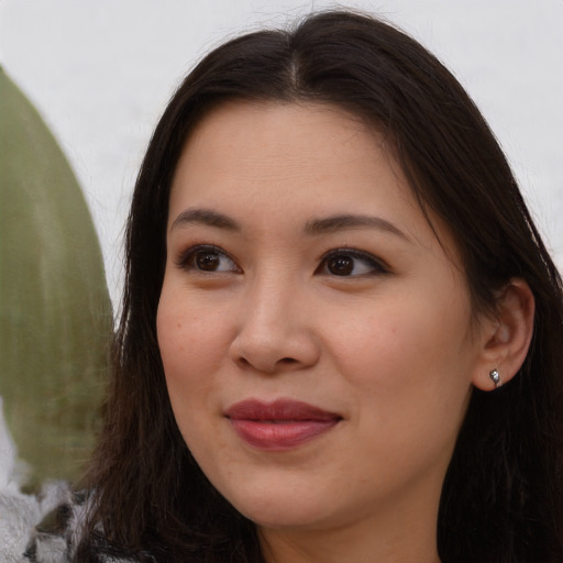 Joyful asian young-adult female with long  brown hair and brown eyes