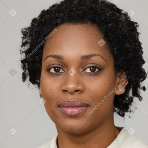 Joyful black young-adult female with short  black hair and brown eyes