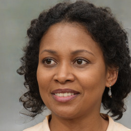 Joyful black adult female with medium  brown hair and brown eyes