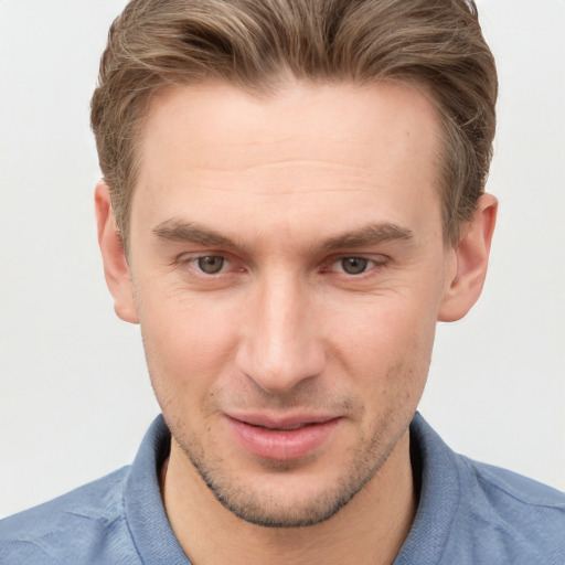 Joyful white young-adult male with short  brown hair and grey eyes