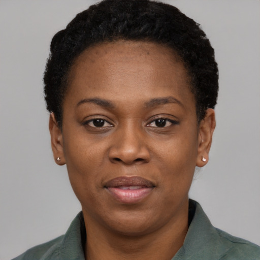 Joyful black adult female with short  black hair and brown eyes