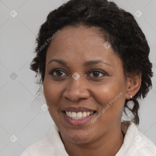 Joyful black adult female with medium  brown hair and brown eyes