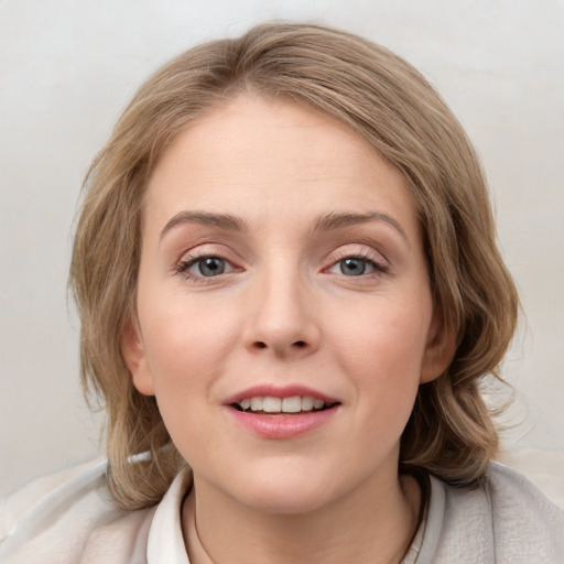 Joyful white young-adult female with medium  brown hair and blue eyes