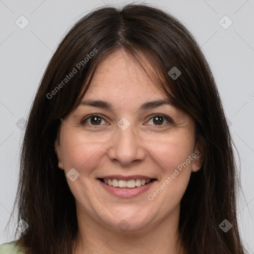 Joyful white adult female with long  brown hair and brown eyes