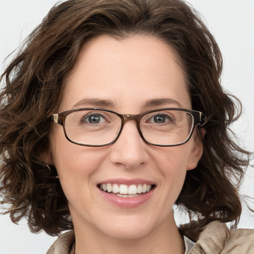 Joyful white adult female with medium  brown hair and blue eyes