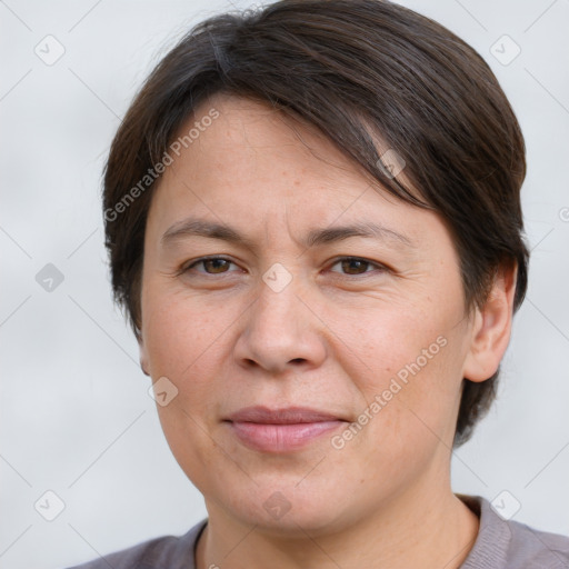 Joyful white adult female with short  brown hair and brown eyes