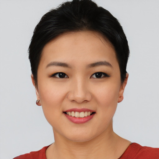Joyful asian young-adult female with short  black hair and brown eyes