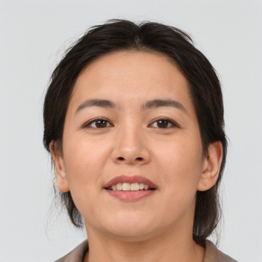Joyful asian young-adult female with medium  brown hair and brown eyes