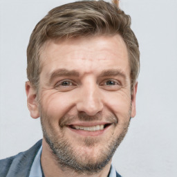 Joyful white adult male with short  brown hair and grey eyes