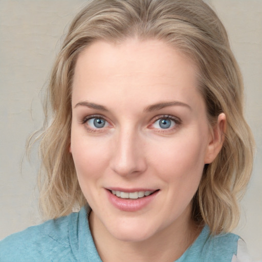 Joyful white young-adult female with medium  brown hair and blue eyes