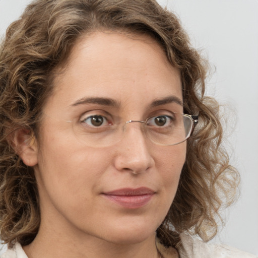 Joyful white young-adult female with medium  brown hair and green eyes