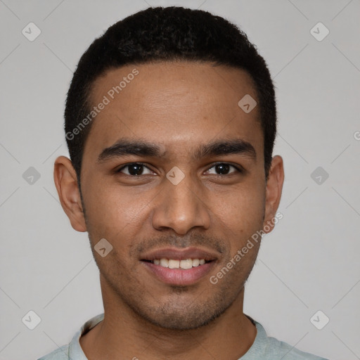 Joyful black young-adult male with short  black hair and brown eyes