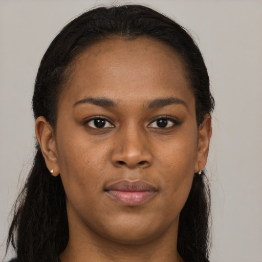 Joyful black young-adult female with long  black hair and brown eyes