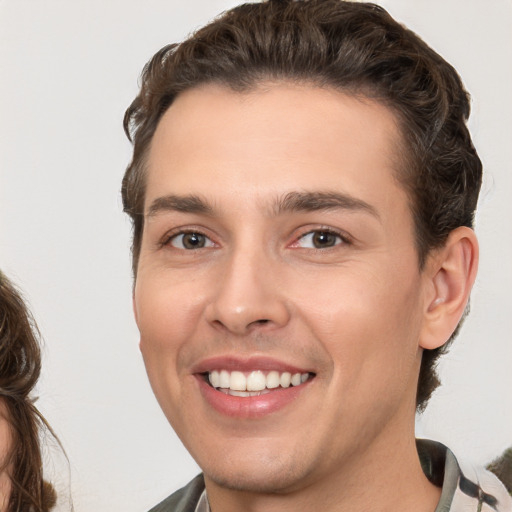 Joyful white young-adult male with medium  brown hair and brown eyes