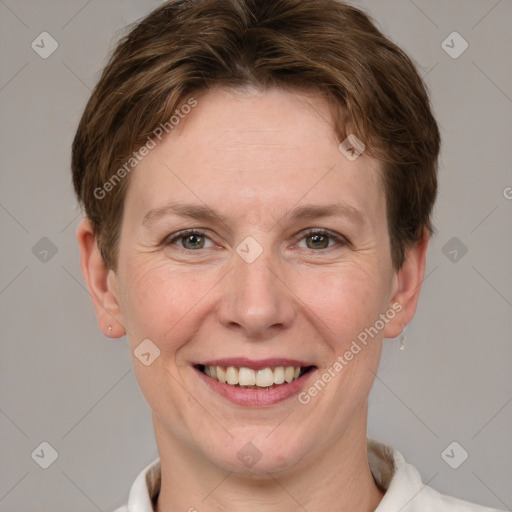 Joyful white adult female with short  brown hair and grey eyes