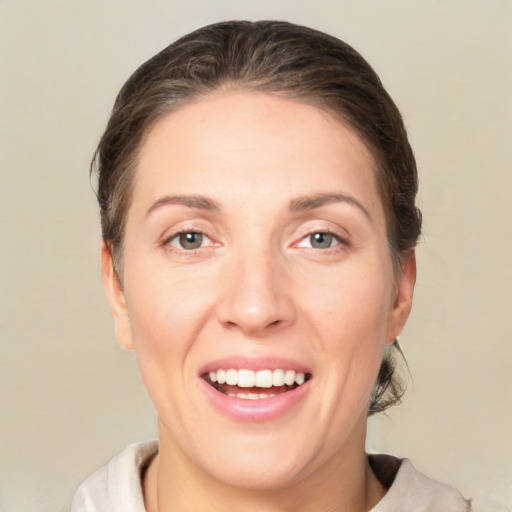 Joyful white young-adult female with short  brown hair and brown eyes